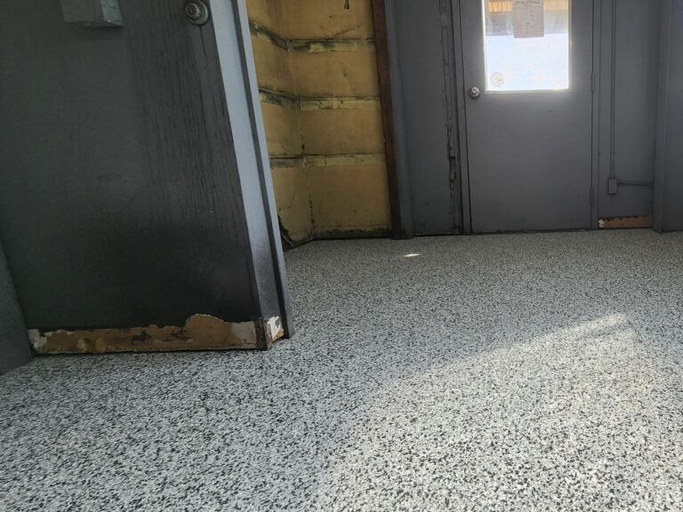Industrial entryway with gray epoxy flake flooring providing a durable, easy-to-clean surface