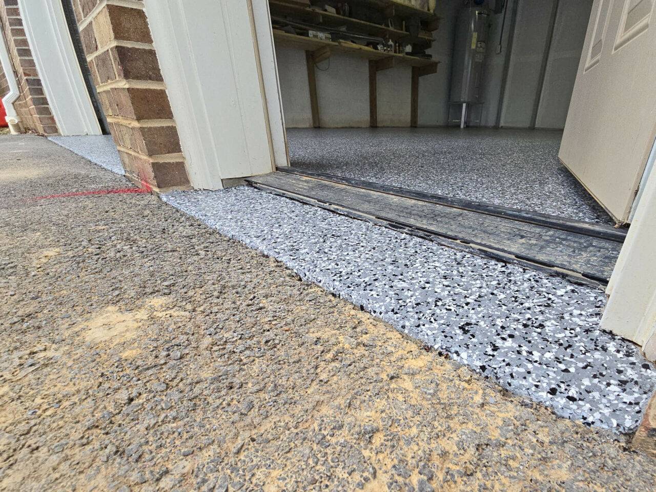Epoxy garage floor coating in Chattanooga with gray flake finish and smooth driveway transition