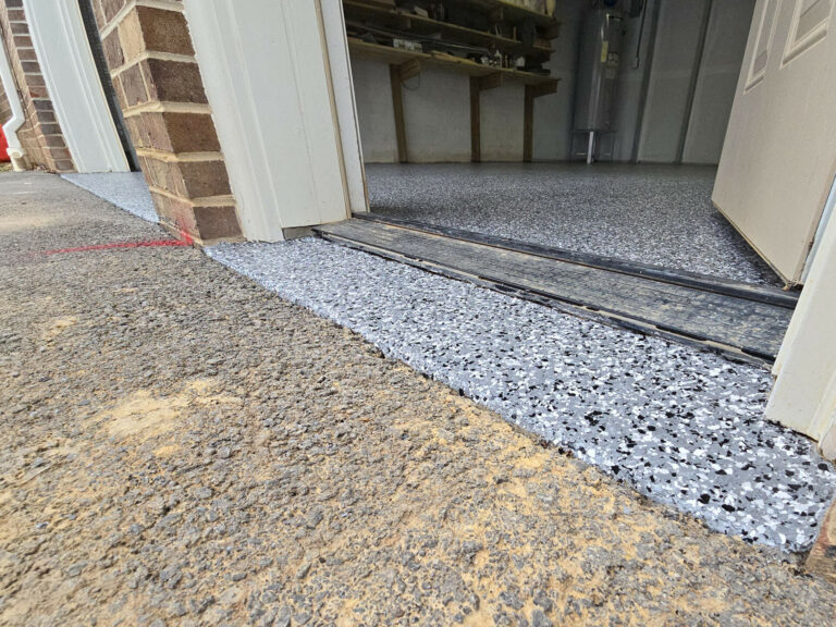 Epoxy garage floor coating in Chattanooga with gray flake finish and smooth driveway transition