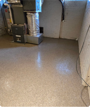 Light brown epoxy flake coating applied to residential basement floor with smooth, durable finish