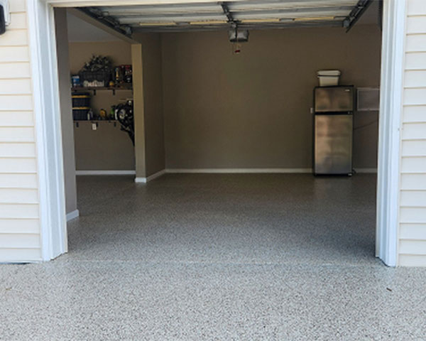 Light gray epoxy flake floor installed in residential garage with clean, durable surface.