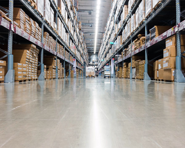 Large warehouse with polished concrete epoxy floor for industrial storage and heavy traffic