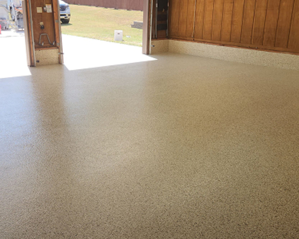 Beige epoxy flake garage floor with seamless finish and durable topcoat